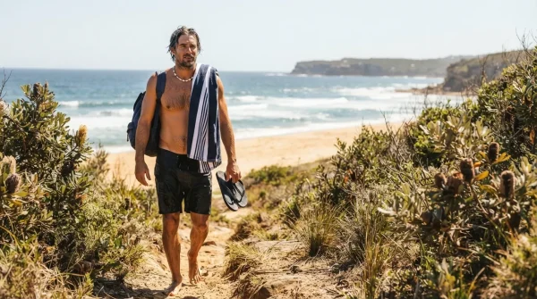 Australian man at the beach in summer, summer skincare routine for men